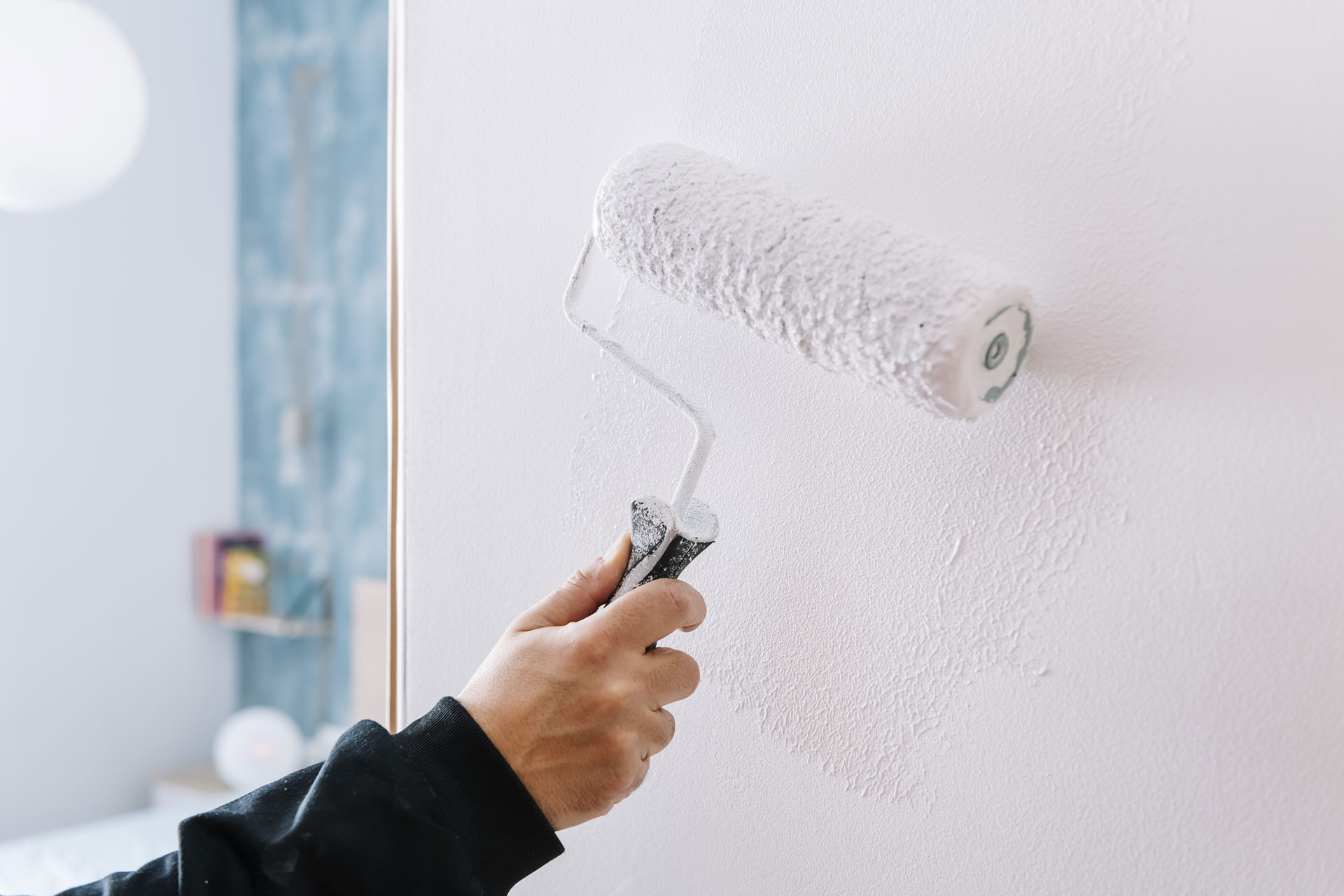 hand painting a wall in white with a roller 2023 11 27 04 57 09 utc 2